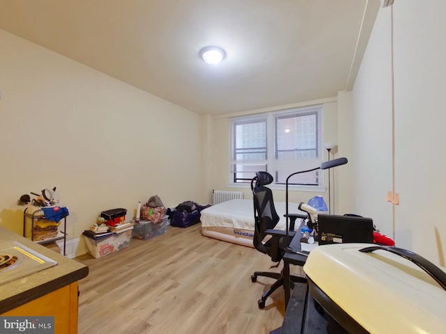 office area featuring radiator and hardwood / wood-style floors