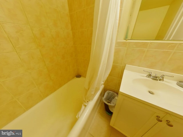 bathroom featuring shower / bath combo with shower curtain and vanity