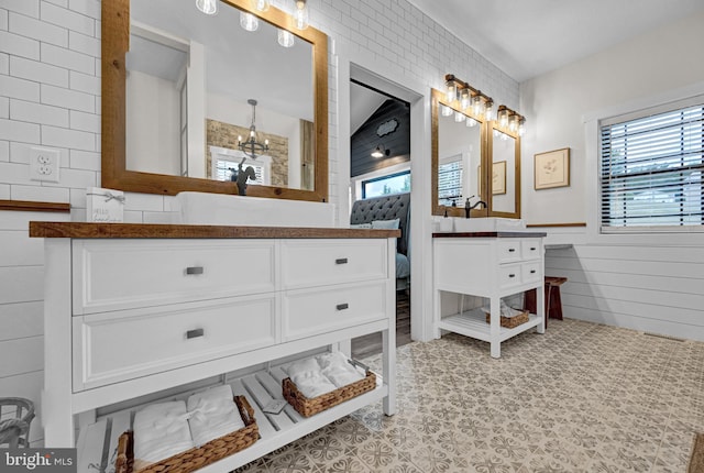 bathroom featuring tile floors, a healthy amount of sunlight, and vanity