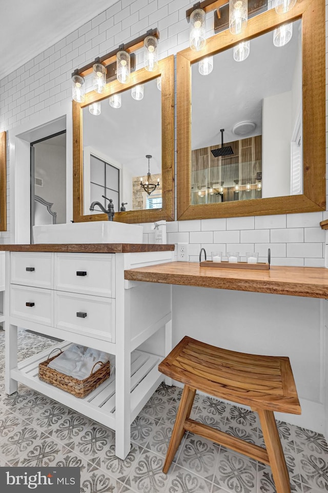 bathroom featuring oversized vanity, crown molding, backsplash, tile walls, and tile floors