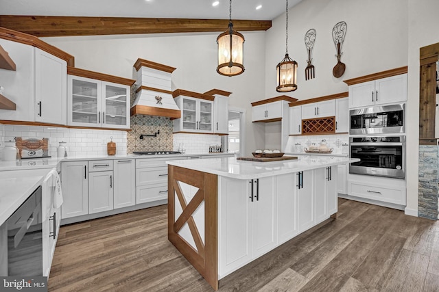 kitchen with backsplash, dark hardwood / wood-style floors, beamed ceiling, white cabinets, and pendant lighting