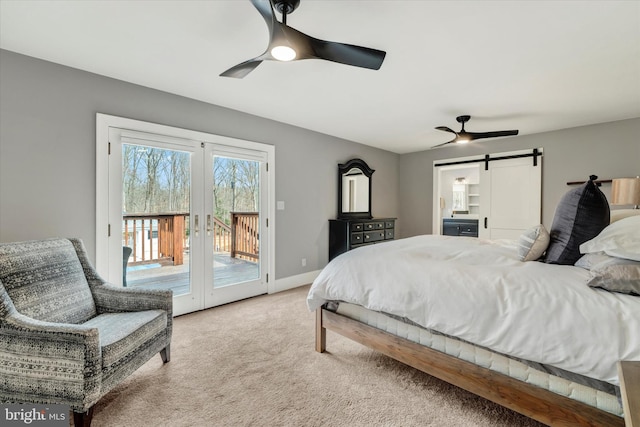 bedroom featuring french doors, access to exterior, a barn door, light colored carpet, and ceiling fan