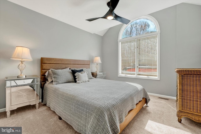 carpeted bedroom with lofted ceiling, baseboards, ceiling fan, and visible vents