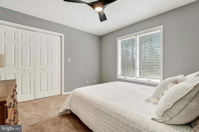 carpeted bedroom with a closet and a ceiling fan