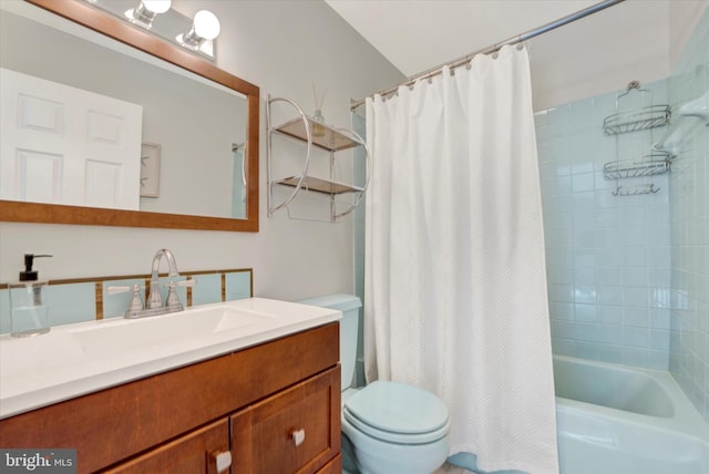 bathroom featuring vanity, toilet, and shower / bath combo