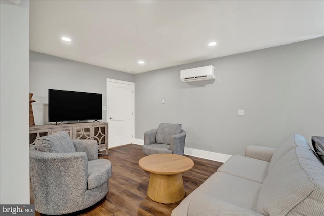 living area featuring recessed lighting, wood finished floors, an AC wall unit, and baseboards