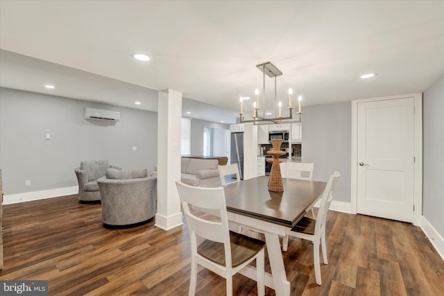 dining space featuring a wall mounted air conditioner, baseboards, and wood finished floors