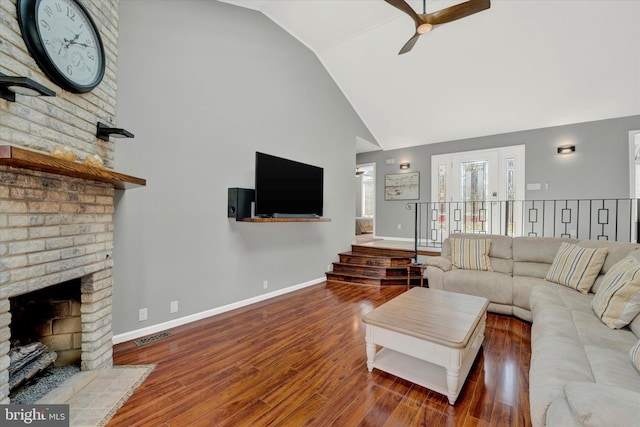 living room with baseboards, wood finished floors, high vaulted ceiling, and ceiling fan