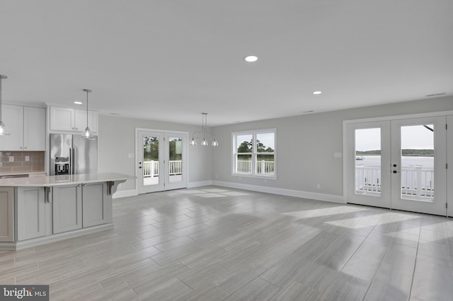 unfurnished living room featuring french doors