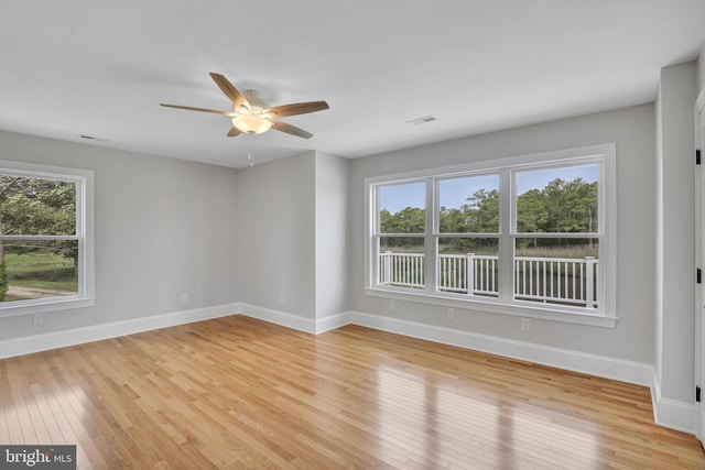 spare room with light hardwood / wood-style floors and ceiling fan