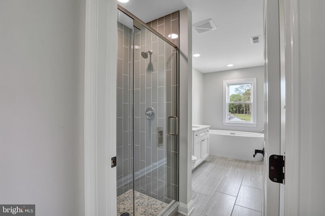 bathroom featuring separate shower and tub, tile floors, and vanity