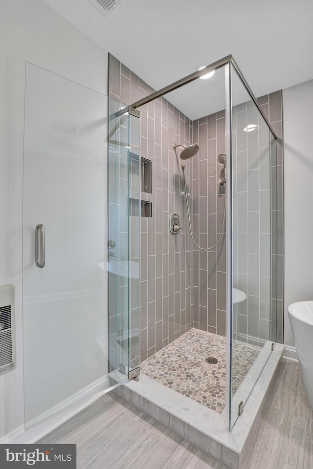 bathroom featuring walk in shower and tile floors