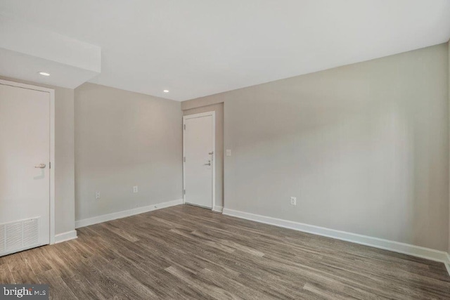 spare room with dark wood-type flooring