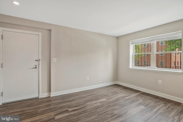 unfurnished room with hardwood / wood-style floors