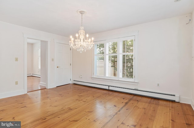 spare room with light hardwood / wood-style flooring, a notable chandelier, and a baseboard heating unit