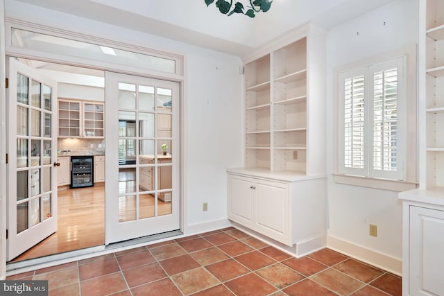 doorway to outside with wine cooler, hardwood / wood-style floors, and french doors