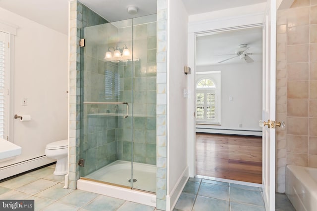 bathroom with toilet, hardwood / wood-style flooring, ceiling fan, separate shower and tub, and a baseboard radiator