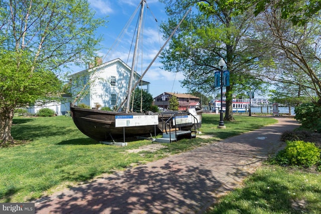 exterior space featuring a yard and a water view