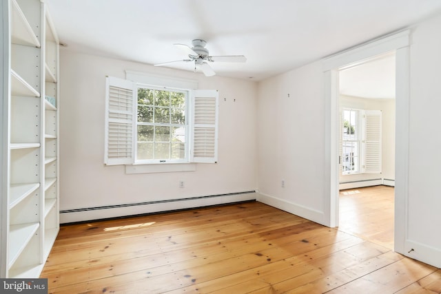 unfurnished room with ceiling fan, a baseboard heating unit, and light hardwood / wood-style flooring