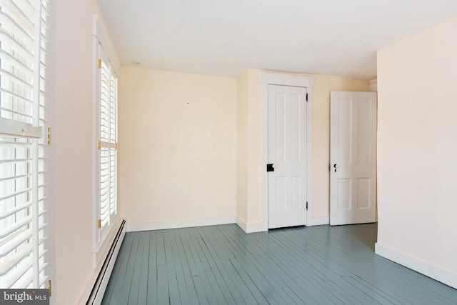 spare room featuring dark hardwood / wood-style flooring and a baseboard radiator