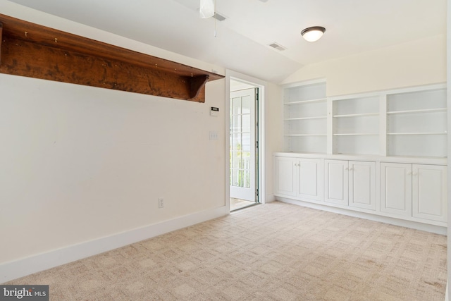 carpeted empty room with ceiling fan and vaulted ceiling