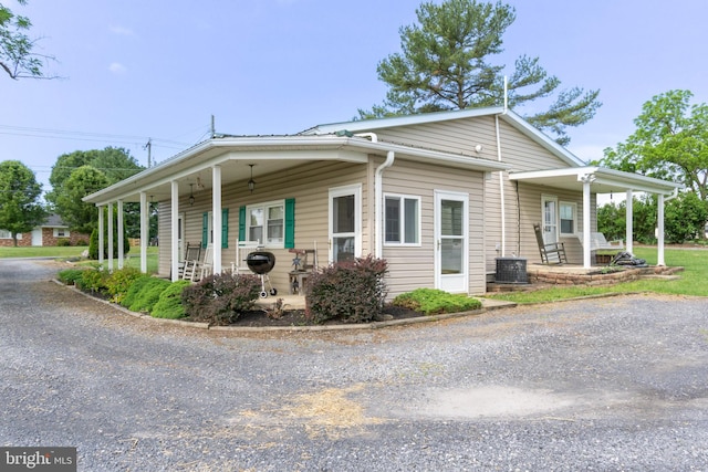 view of property exterior featuring a porch and central air condition unit