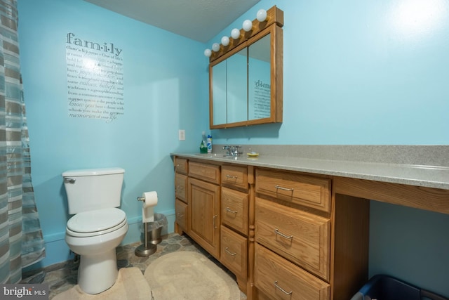 bathroom featuring vanity, toilet, and walk in shower