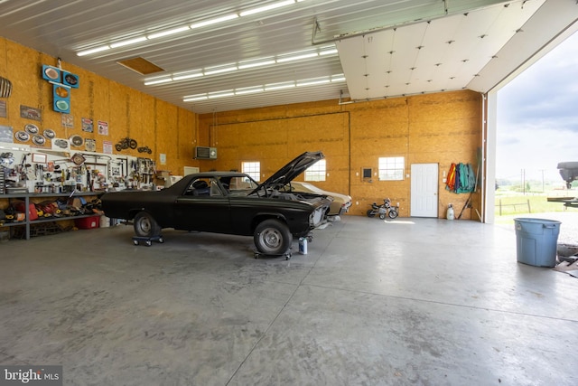 garage featuring a workshop area and wooden walls