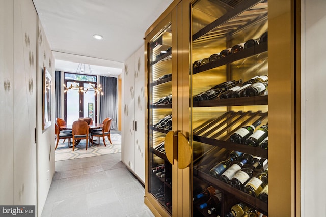 wine cellar featuring a notable chandelier and light tile floors