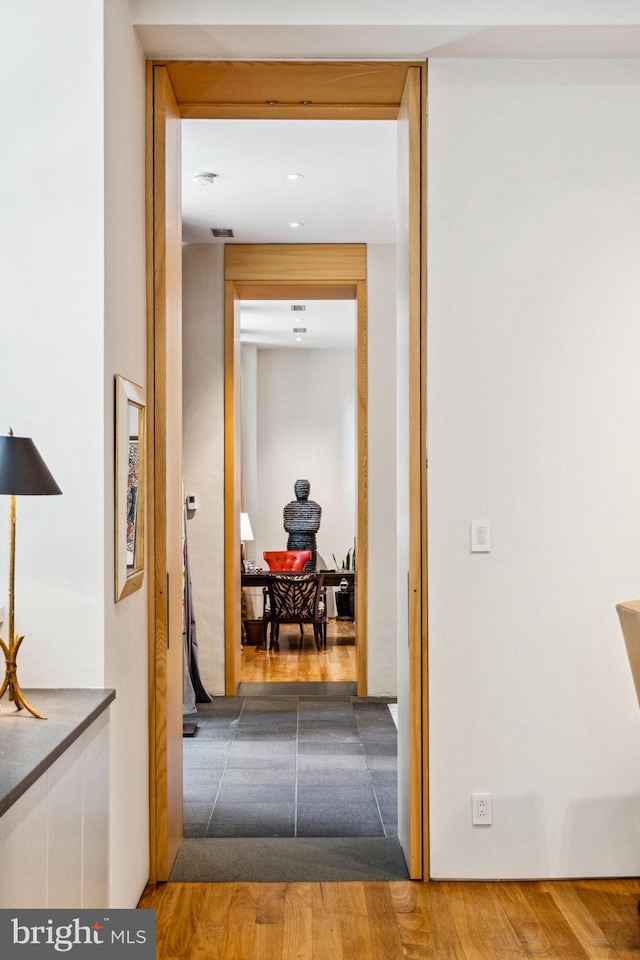 hallway with light hardwood / wood-style flooring