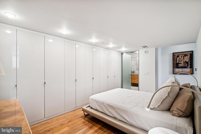 bedroom featuring a closet and light wood-type flooring