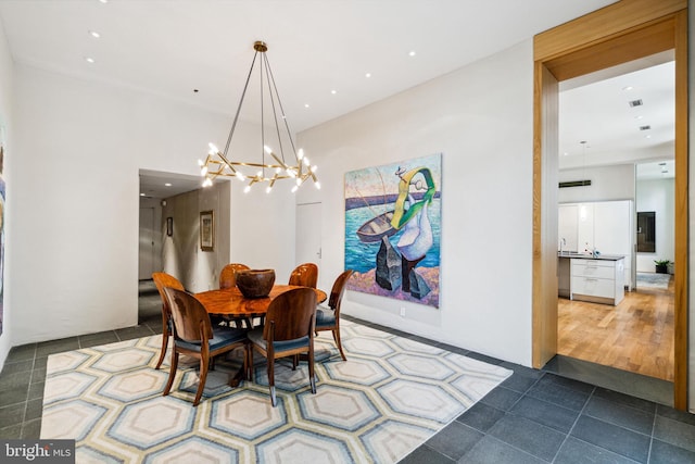 dining space with light tile flooring and a notable chandelier