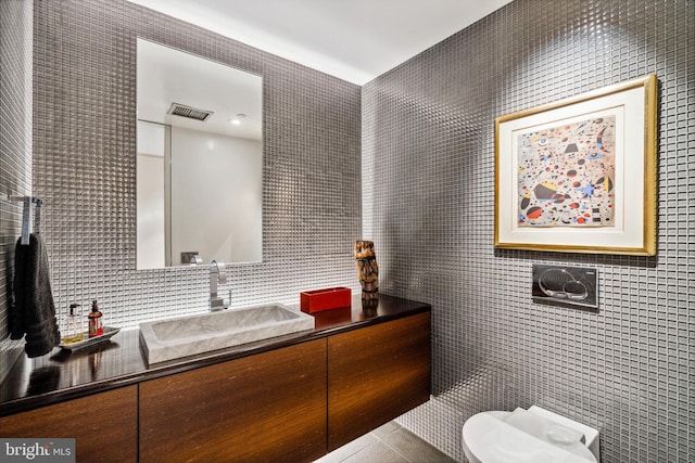 bathroom featuring tile walls and vanity