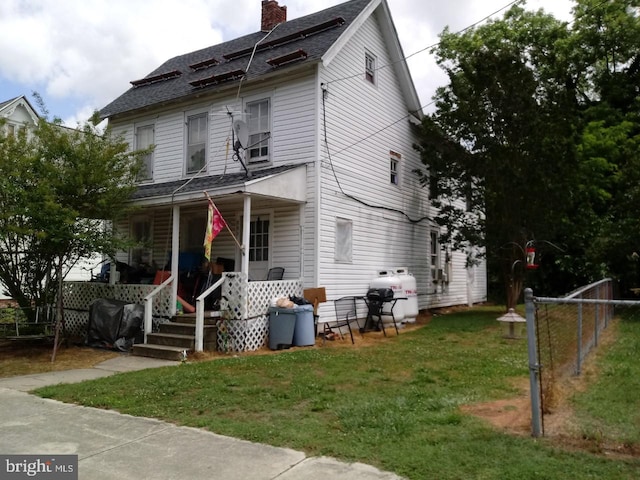 front facade with a porch and a front lawn