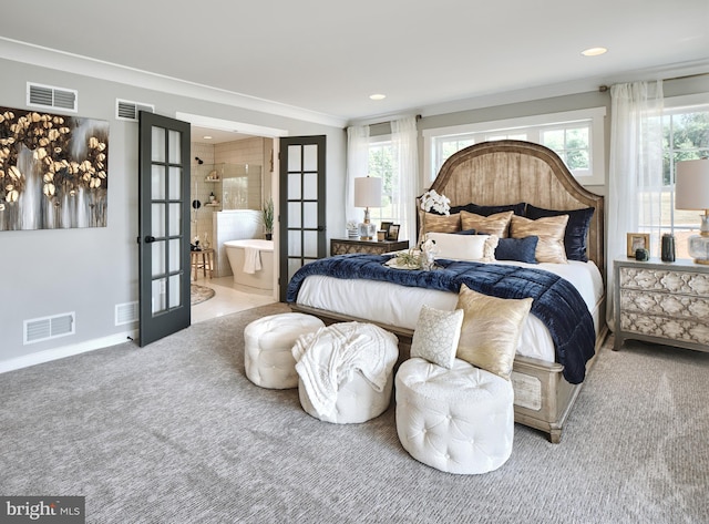 bedroom featuring ornamental molding, carpet, ensuite bath, and french doors