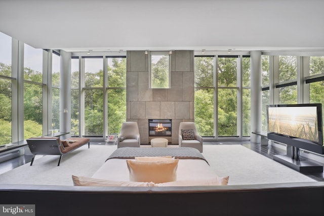 sunroom with a tile fireplace