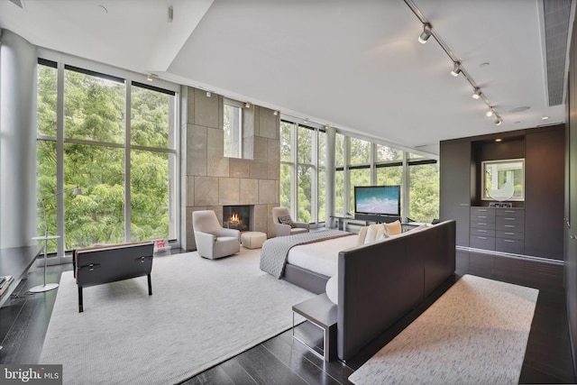 sunroom with plenty of natural light and a tiled fireplace