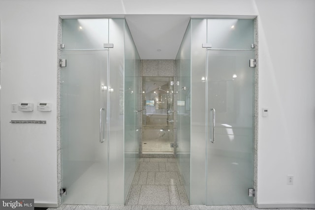 bathroom with a shower with shower door