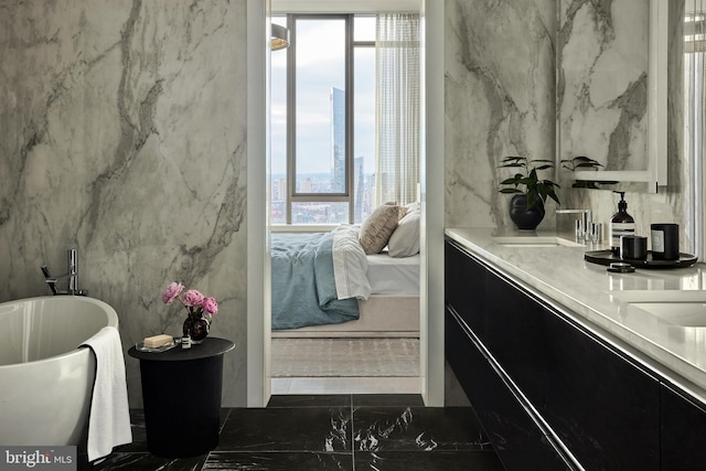 bathroom featuring vanity and a washtub