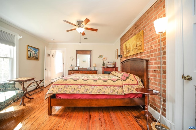 bedroom featuring brick wall, ceiling fan, dark hardwood / wood-style floors, and crown molding