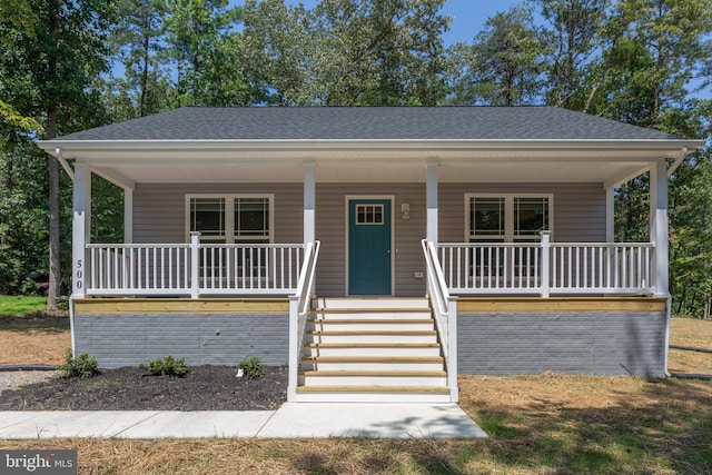 view of front of home featuring a porch and roof with shingles