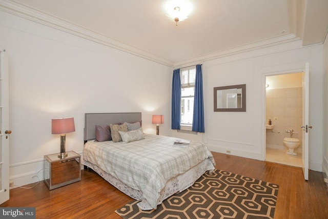 bedroom with tile walls, crown molding, connected bathroom, and dark hardwood / wood-style flooring