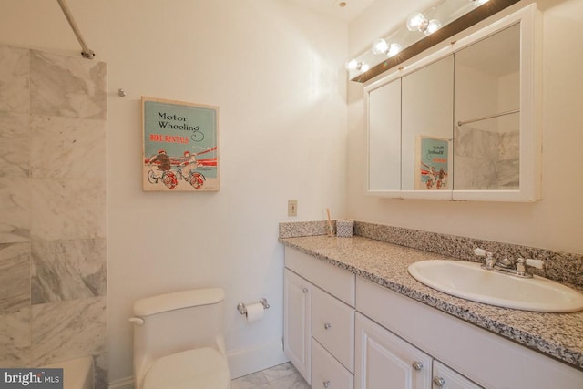 bathroom with tile flooring, toilet, and vanity with extensive cabinet space