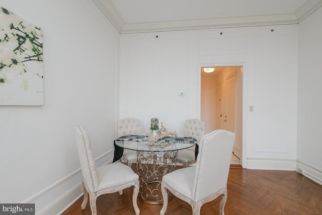 dining room with crown molding and dark parquet flooring