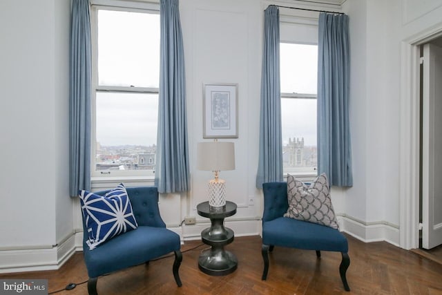 sitting room with dark parquet floors