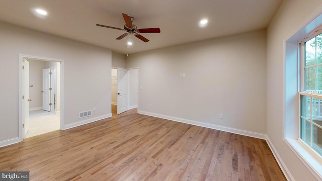 spare room featuring light wood-style flooring, visible vents, baseboards, and recessed lighting