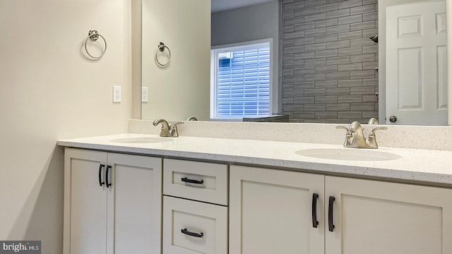 full bath with double vanity and a sink