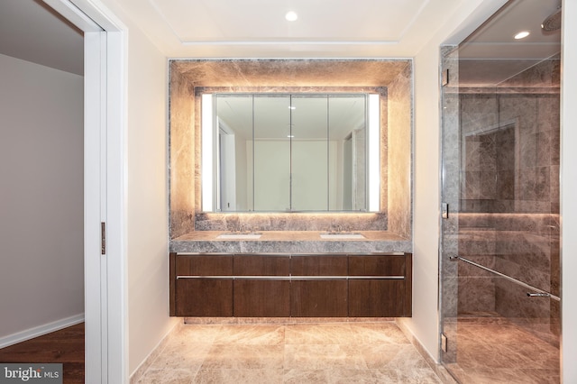 bathroom with vanity with extensive cabinet space, tile floors, and a tile shower