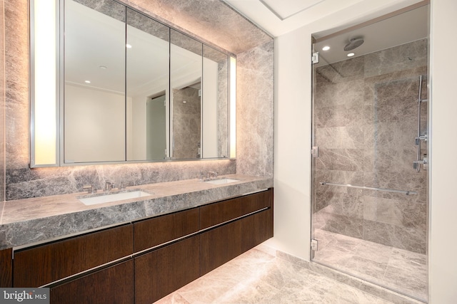 bathroom featuring tile walls, double sink, a tile shower, and oversized vanity