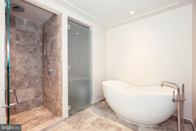 bathroom featuring tile floors and tiled shower